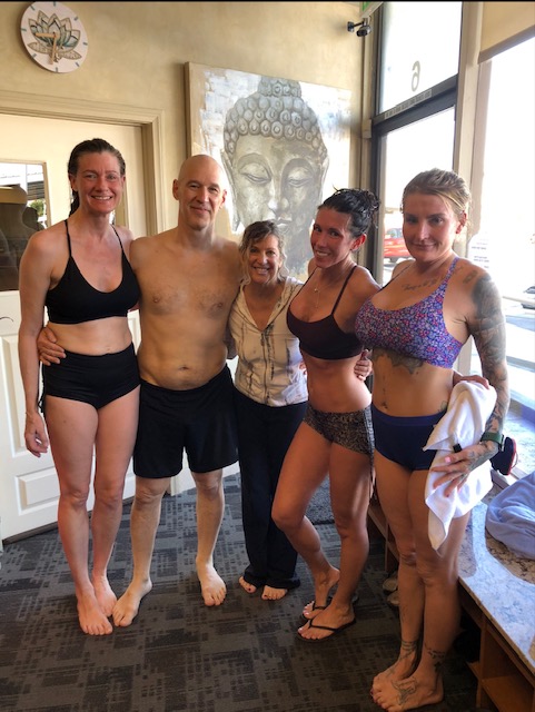 Group of smiling Bikram Yoga El Paseo students after class, celebrating their practice.